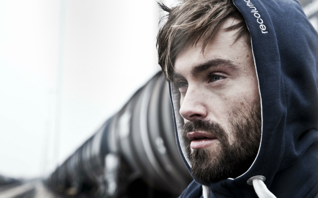 close up photo of man's face wearing hoodie