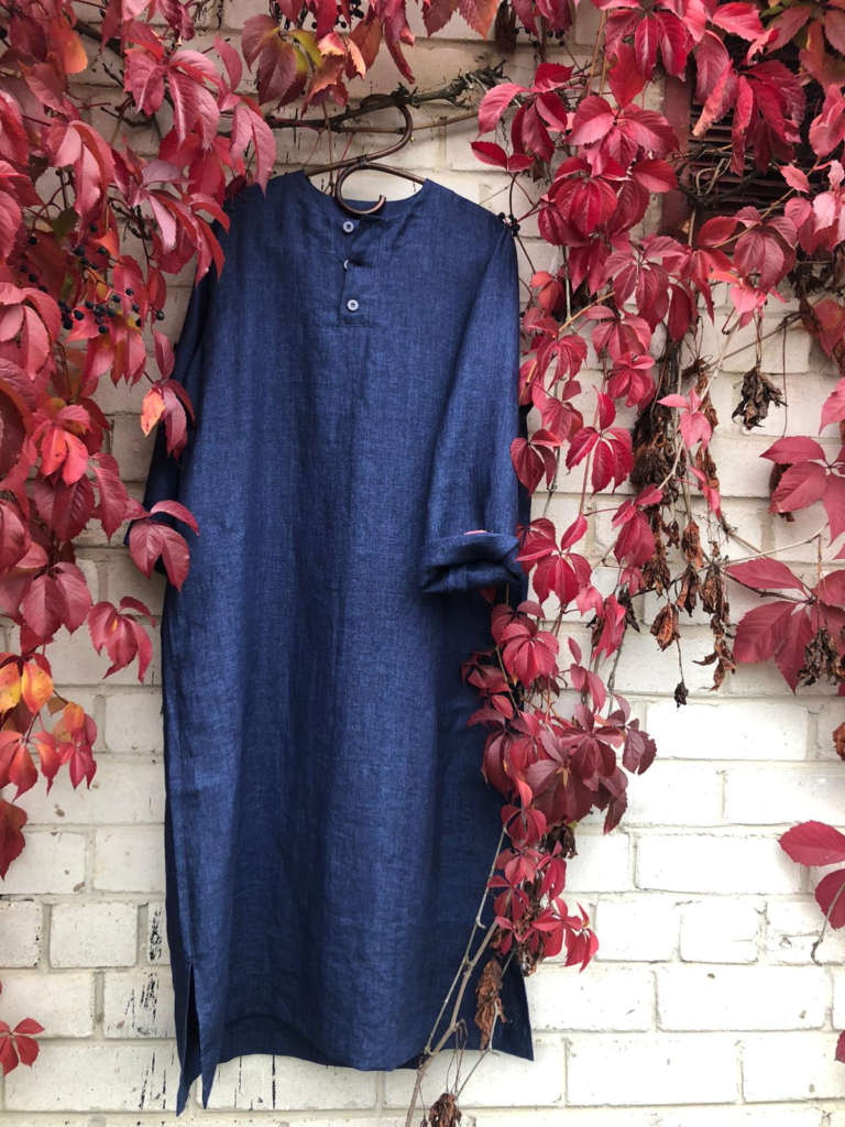blue colored dress hanging in a tree