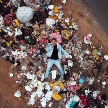 man laying in pile of plastic