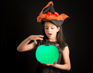 hallogreen girl holds green pumpkin