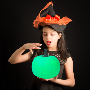 hallogreen girl holds green pumpkin