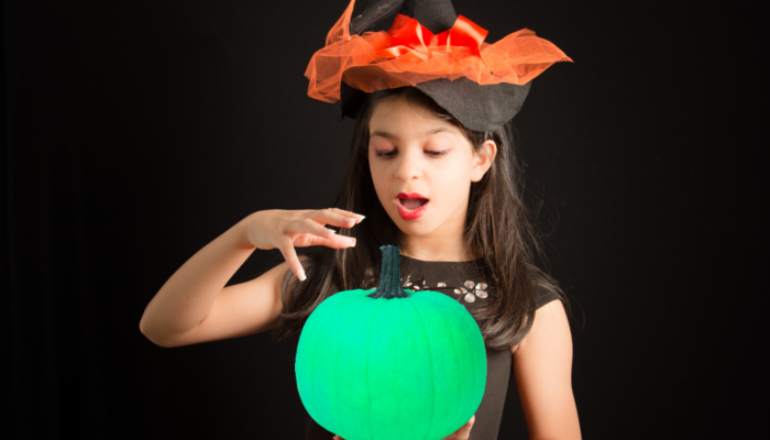 hallogreen girl holds green pumpkin