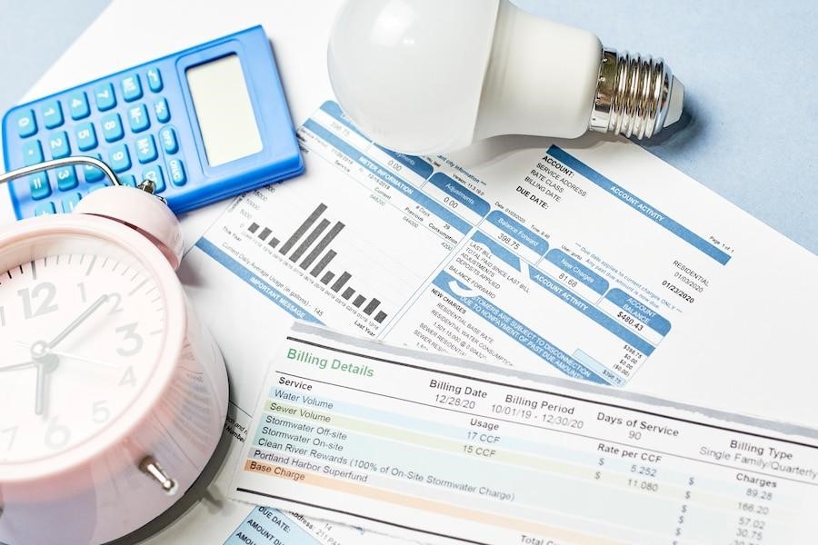 a bulb ,calculator. table clock on billing documents