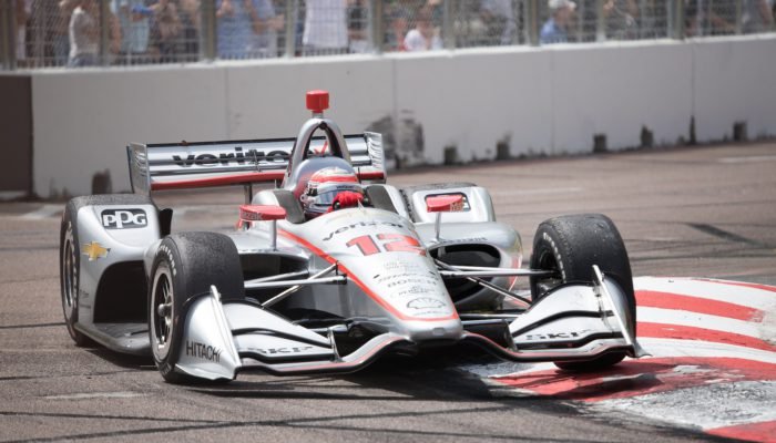 white and red f 1 car on road