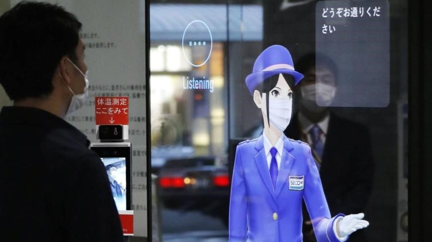 A virtual AI guide displayed on an electric panel welcomes visitors to Ogikubo Hospital in Tokyo.