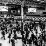 Grayscale Photography of People Walking in Train Station
