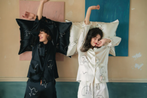 two women waking up from sleep wearing pajamas