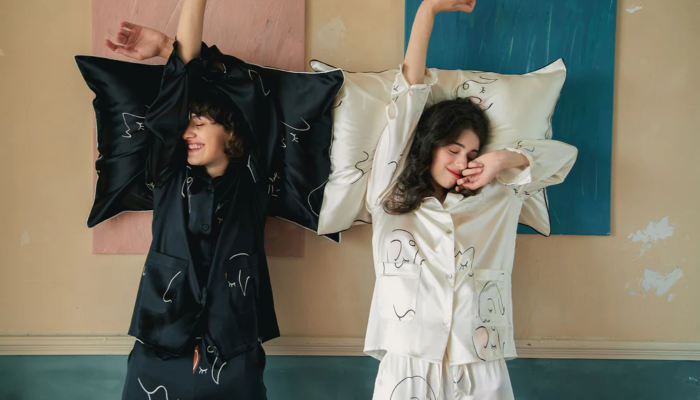 two women waking up from sleep wearing pajamas
