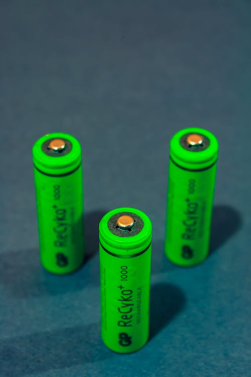 green colored battery standing on table