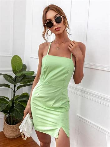 female posing for photoshoot wearing green dress and sunglass