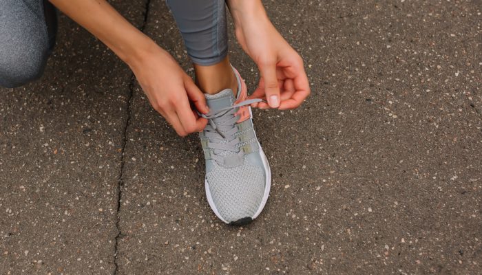 Person Tying Up Her Shoelace