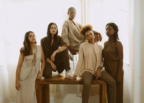 five women posing for fashion photoshoot