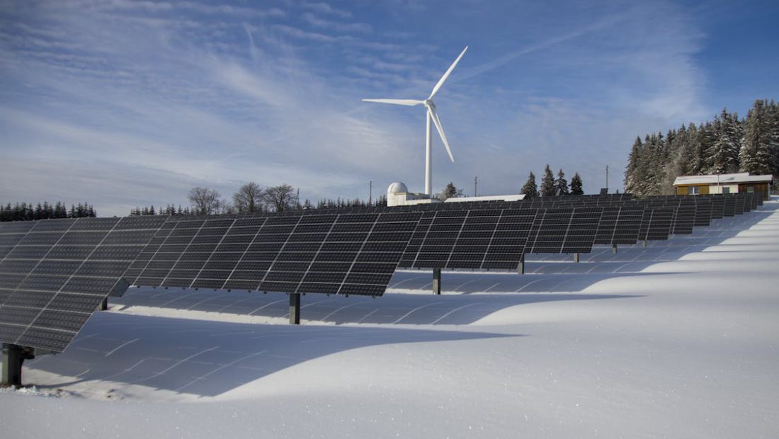 wind turbine and solar panels in a ice covered area