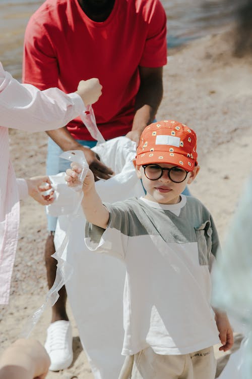 child wearing cap and glass