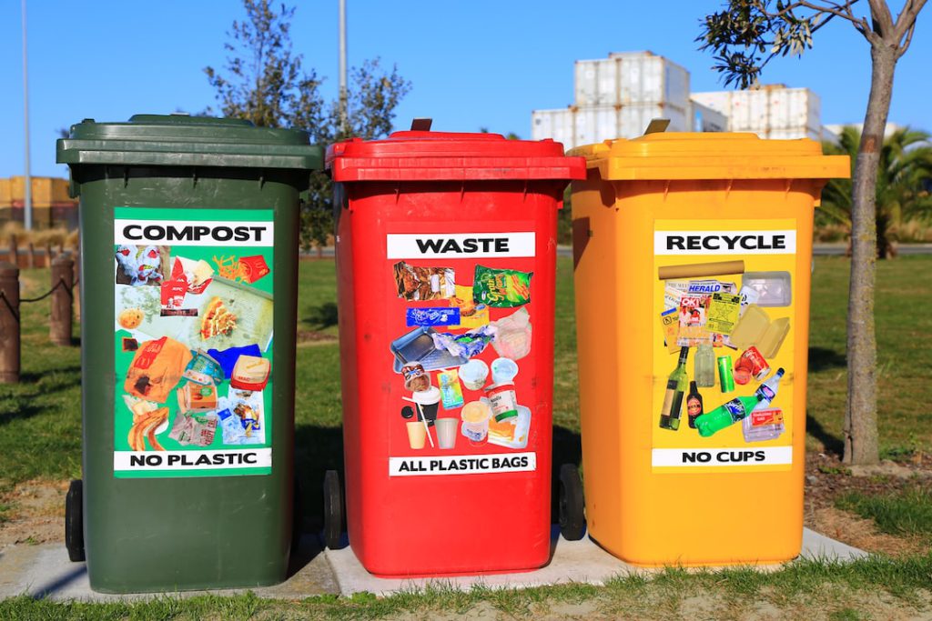 three different colored trash bin