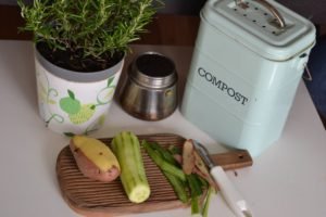 vegetable and plant pot and a bin written compost on it