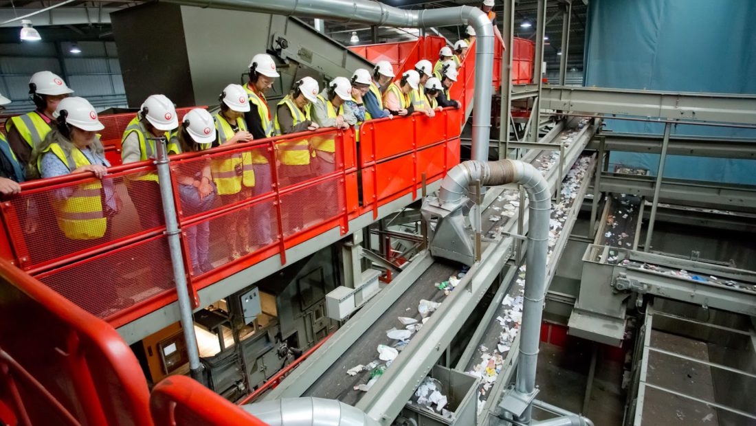 recycling facility workers monitoring the process