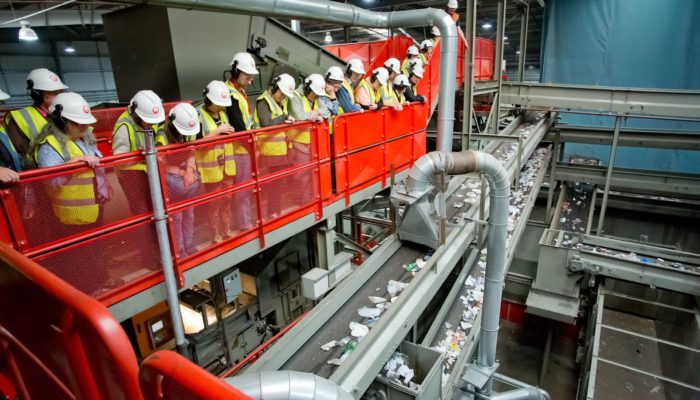 recycling facility workers monitoring the process