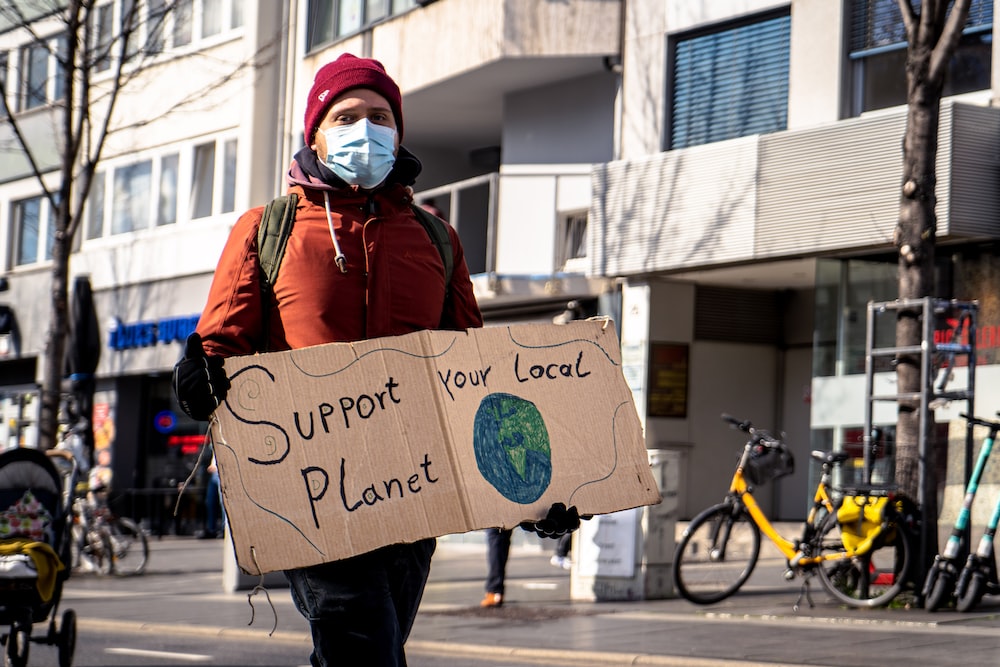 person holding support planet placard