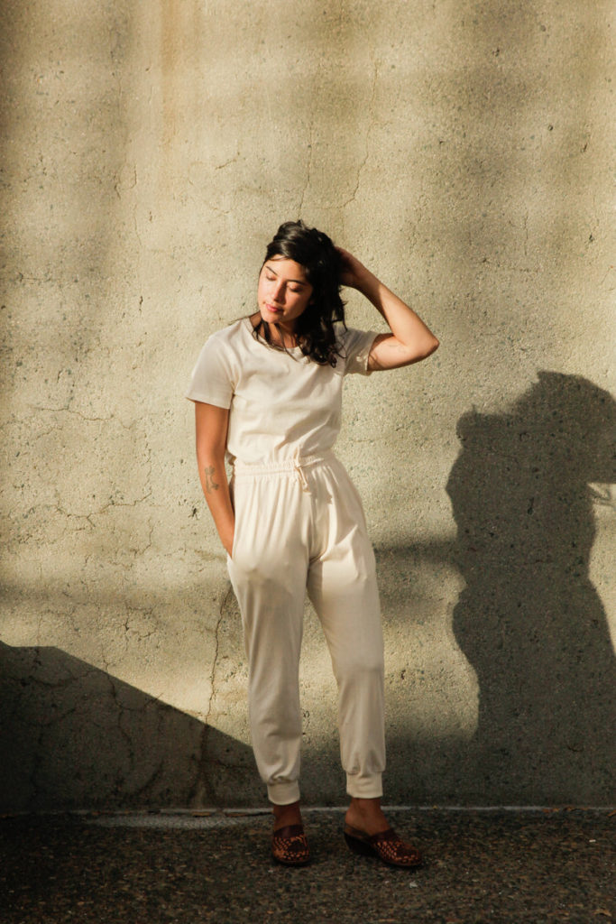 women standing in front of wall wearing white top and joggers