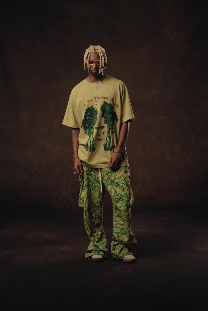 black person standing for photoshoot wearing t shirt 