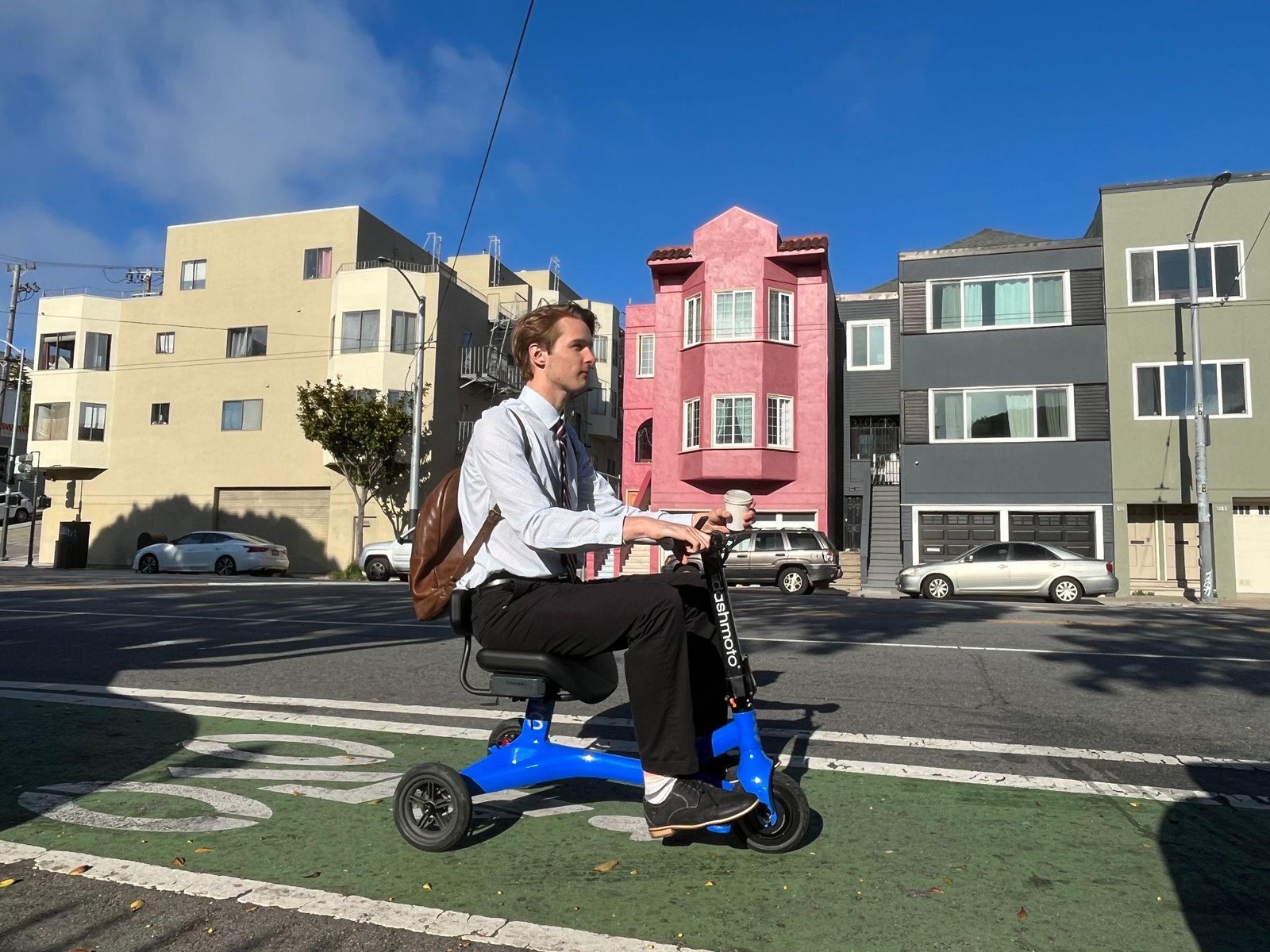 a person commuting an electric scooter in urban road