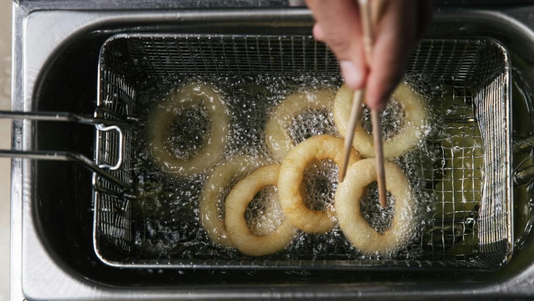 Photo of a Person's Hand Cooking Onion Rings