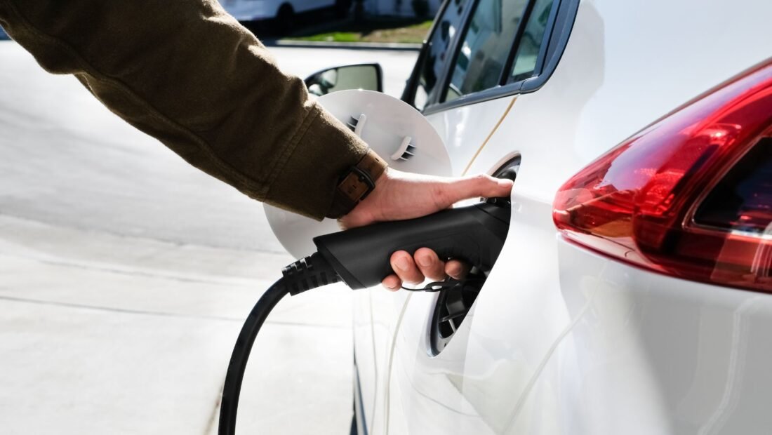 person using ev charger to charge an ev