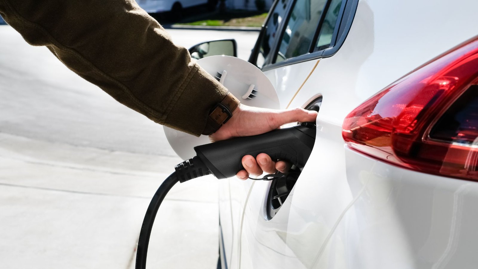 person using ev charger to charge an ev